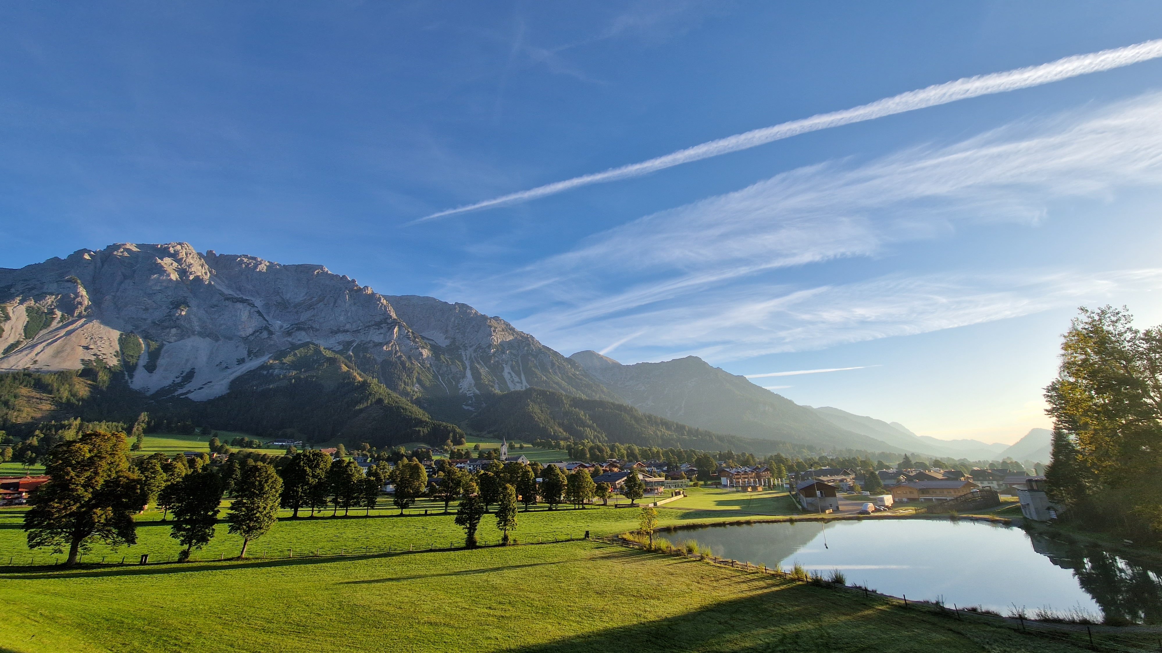 Serene Mountain Reflection Scenic landscape with mountains, clear sky, and calm water reflecting surroundings